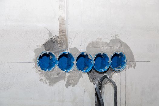 The electrician will plaster holes and channels for sockets and wires. Repair of apartments. Close-up