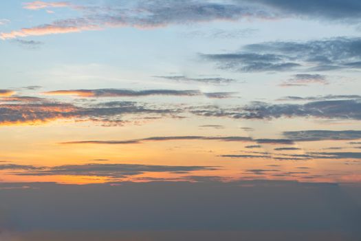 Scenic Colorful Sky At Sunset. Light blue clouds and orange on background, The softness of the cloud creates a feeling of relaxation. Copy space. No focus, specifically.