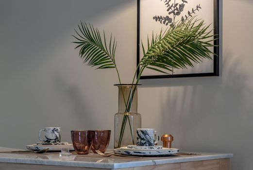 Dining table with vase of flower on marble table in home dining room. Interior design concept.