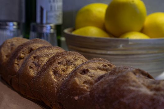 Close-up of French Baguette and lemons on kitchen table. Selective focus.