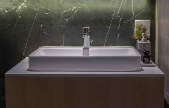 Wash basin and faucet in the bathroom, Space for text. No focus, specifically.