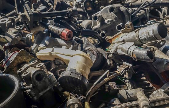 Close-up of Used and surplus car engines  & accessories of the car at the repair service garage. Selective focus.