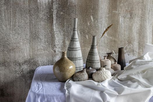 Handmade Assorted Many Different Ceramic Vases on white table. Home decor, Space for text.