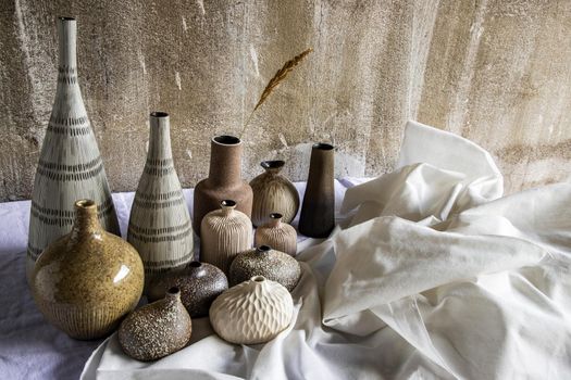 Handmade Assorted Many Different Ceramic Vases on white table. Home decor, Space for text.