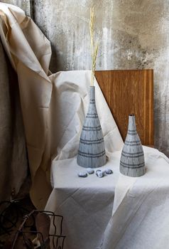 Handmade Double ceramic Vases on wooden chair. Home decor, Space for text.