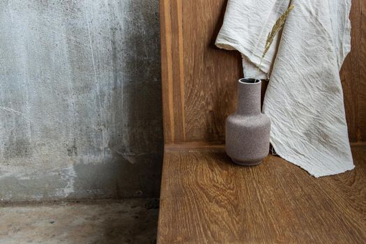 Handmade Ceramic Vase on wooden chair. Home decor, Space for text.