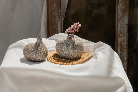Dried flowers in Handmade Double Ceramic Vases on table. Home decor, Space for text.