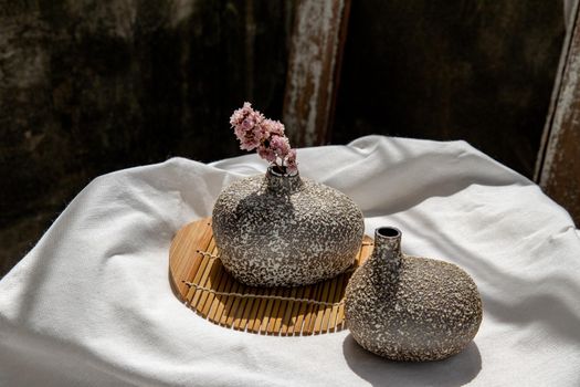 Dried flowers in Handmade Double Ceramic Vases on table. Home decor, Space for text.