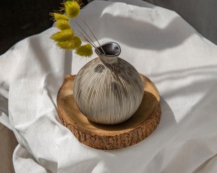 Dried flowers in Handmade Ceramic Vases on Wooden Board. Home decor, Space for text.