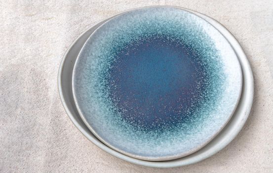Set of Ceramic Plates on Calico. Ceramic tableware, Beautiful arrangement, Copy space.