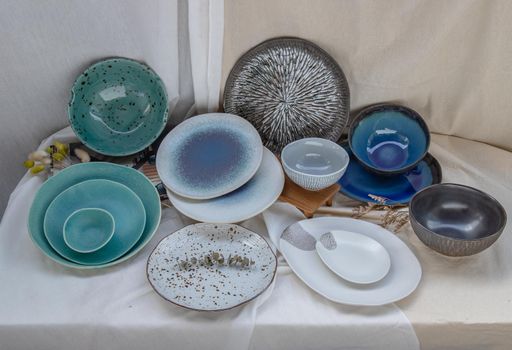 Different Ceramic Plates and Bowl on Calico. Ceramic tableware, Beautiful arrangement.