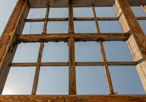 The old wooden battens roof structure of the outdoor vegetable garden. Selective focus.