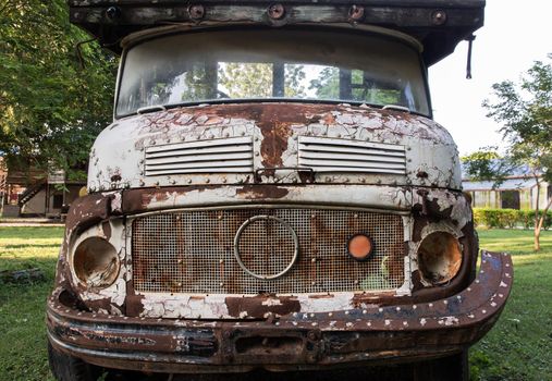 Front view of Rusty old logging truck. Abandoned car, selective focus.