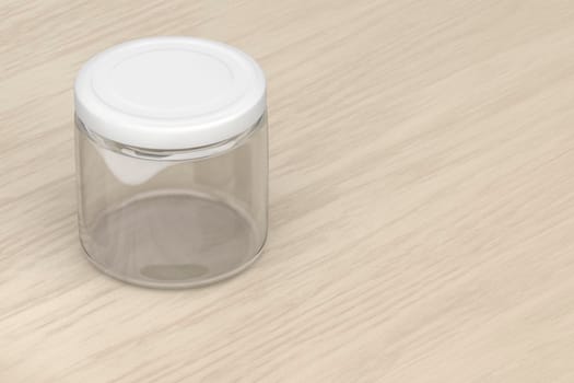 Empty glass jar on a wooden table