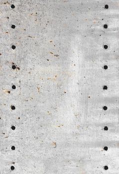 Gray metal structure, with holes. Scratched metal. Design background.