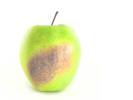 Rotten green apple on a white background.