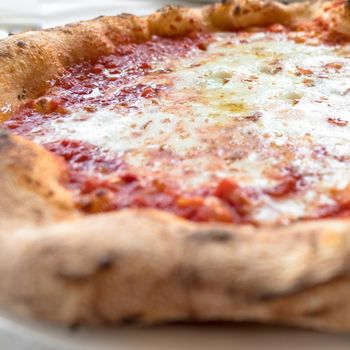 Pizza Margherita made with tasty pizza dough, mozzarella and tomatoes.