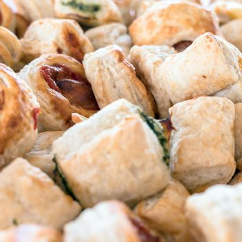 Small pizzas. Close-up. Mix of delicious appetizers. Small pizzas made of puff pastry.