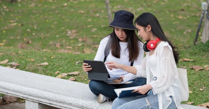 College asian students studying together in campus ground