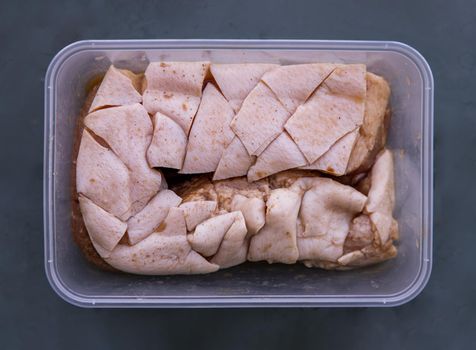 Raw pork belly portions, Marinated rolled pork belly ready for deep fried. Selective focus.