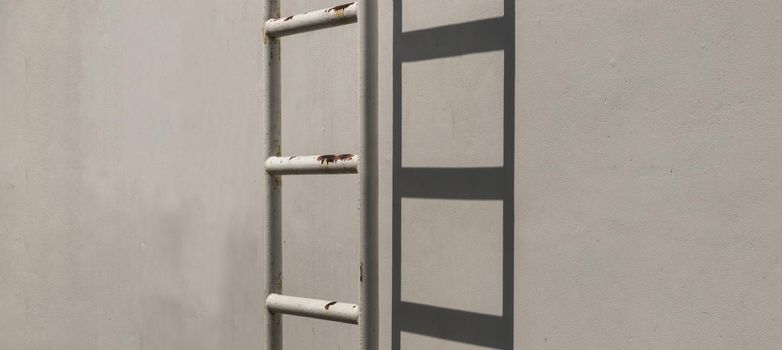 White metal fire escape attached to a wall and leading to the roof of a building. Copy space, No focus, specifically