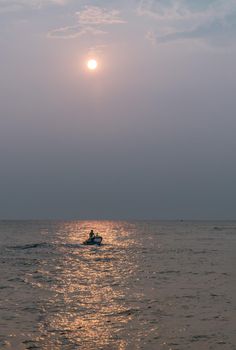 Phetchaburi,Thailand - Mar 15, 2020 : The fisherman and wooden fishing boat used as a vehicle for finding fish in the sea. Selective focus.