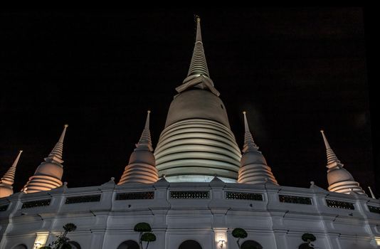 Bangkok, Thailand - 25 Jan 2020 : Phra Borommathat Maha Chedi, The main big white pagoda at night that is a landmark of Wat Prayurawongsawas Warawihan.