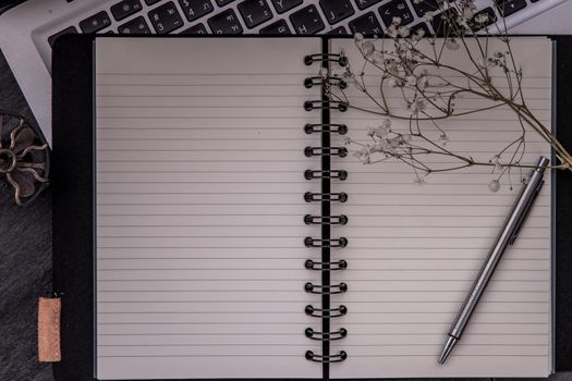 Open empty blank notebook organizer with pen for planning work on laptop, Concept for business. Planning or diary. Great for any use. Top view