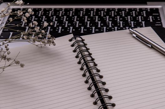 Open empty blank notebook organizer with pen for planning work on laptop, Concept for business. Planning or diary. Great for any use. Oblique view from the top