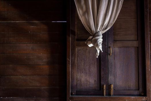 Textured background: Wooden pattern of Window and White lace curtains in traditional thai house, Thai Style architecture.