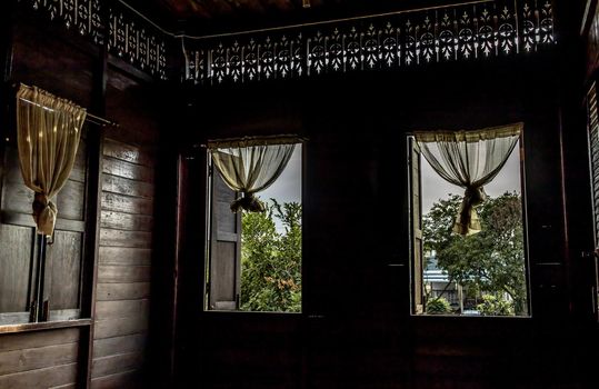 Textured background: Wooden pattern of Window and White lace curtains in traditional thai house, Thai Style architecture.