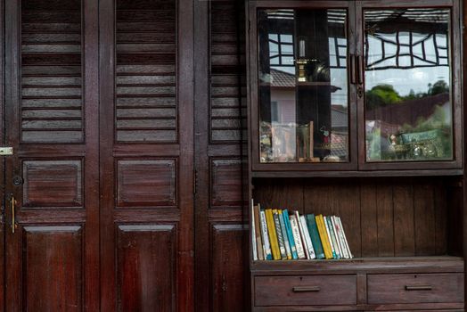 Bangkok, Thailand - 15 Dec 2019 : Interior design in Thai style with Wooden dresser classic and Books, Thai Style architecture.