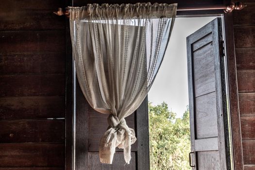 Textured background: Wooden pattern of Window and White lace curtains in traditional thai house, Thai Style architecture.