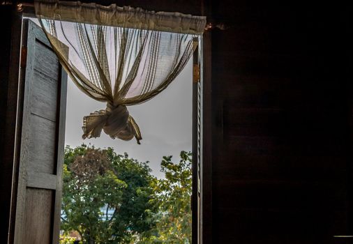 Textured background: Wooden pattern of Window and White lace curtains in traditional thai house, Thai Style architecture.