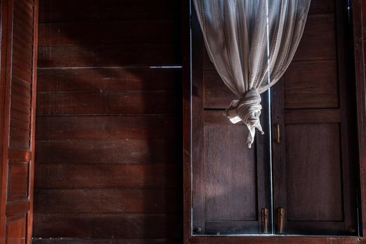 Textured background: Wooden pattern of Window and White lace curtains in traditional thai house, Thai Style architecture.
