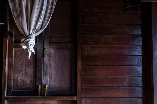 Textured background: Wooden pattern of Window and White lace curtains in traditional thai house, Thai Style architecture.