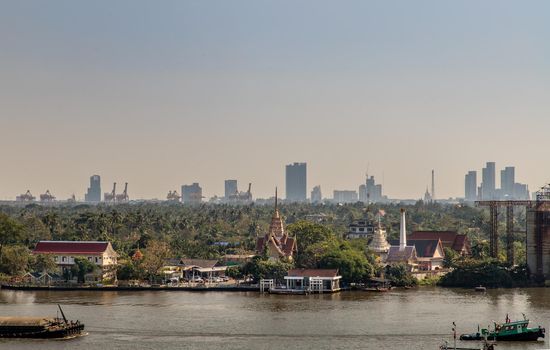Bangkok, Thailand - Jan 04, 2020 : The view of the Chao Phraya River that sees Wat Bangkrachaonok and the green area next to the river, which is called Bang Krachao, Beautiful nature.