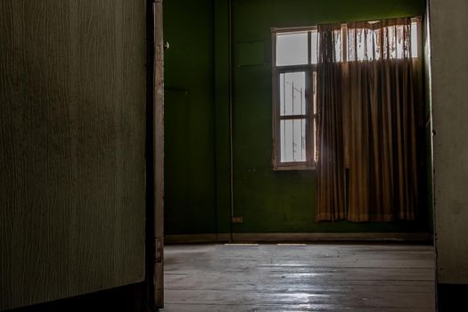 Bangkok, Thailand - Jan 19, 2020 : Abandoned room with big window was left to deteriorate over time, Abandoned house, Destroyed house, Ruined house.