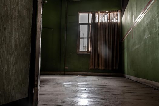 Bangkok, Thailand - Jan 19, 2020 : Abandoned room with big window was left to deteriorate over time, Abandoned house, Destroyed house, Ruined house.