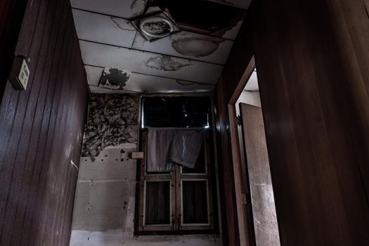 Bangkok, Thailand - Jan 19, 2020 : Abandoned room with window was left to deteriorate over time, Abandoned house, Destroyed house, Ruined house.