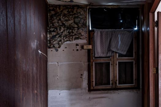 Bangkok, Thailand - Jan 19, 2020 : Abandoned room with window was left to deteriorate over time, Abandoned house, Destroyed house, Ruined house.