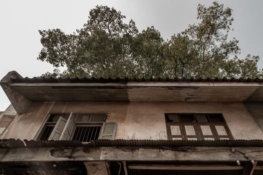 Bangkok, Thailand - Jan 19, 2020 : External of old house was left to deteriorate over time, Chinese Architecture style, Abandoned house, Destroyed house.
