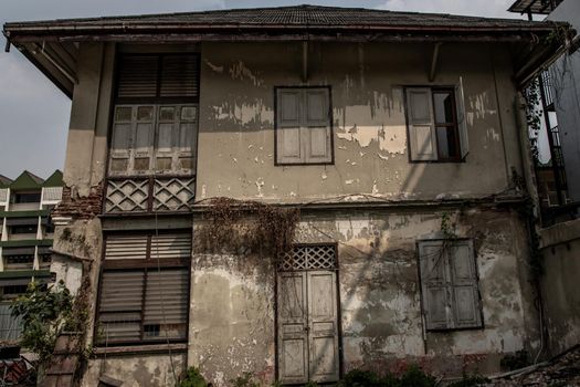 Bangkok, Thailand - Jan 19, 2020 : External of old building was left to deteriorate over time, Chinese Architecture style, Old abandoned house, Destroyed house, Ruined house.