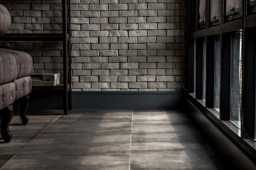 Bangkok, Thailand - 15 Dec 2019 : Minimalist interior of living room with sofa, brick wall and windows, Loft style room. Copy space.