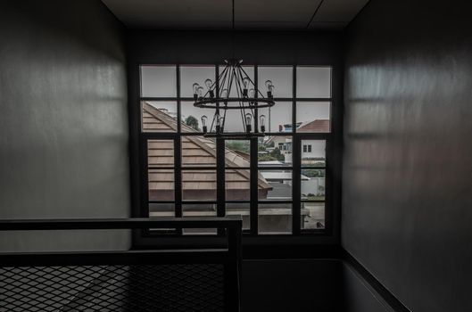 Bangkok, Thailand - 15 Dec 2019 : View of windows on a a stairway from 1st floor to 2nd floor in loft style home.