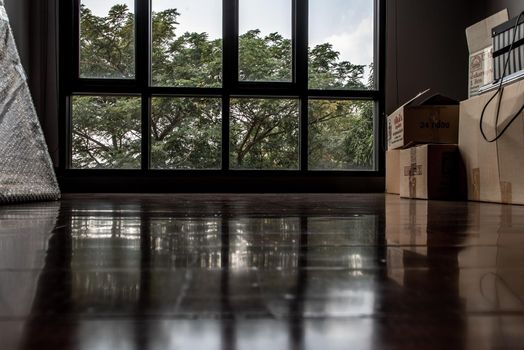 Bangkok, Thailand - 15 Dec 2019 : Empty room with Storage box and windows in loft style. Wooden floor and brick wall in a modern interior.