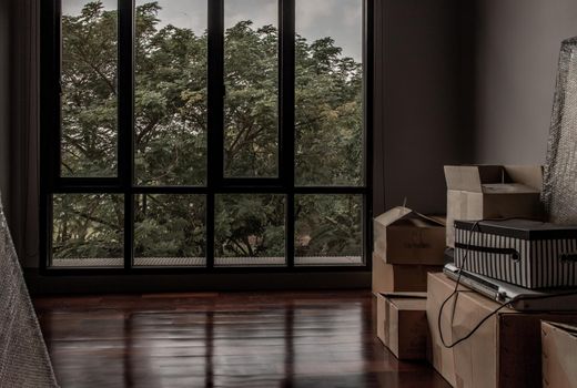 Bangkok, Thailand - 15 Dec 2019 : Empty room with Storage box and windows in loft style. Wooden floor and brick wall in a modern interior, Selective focus.