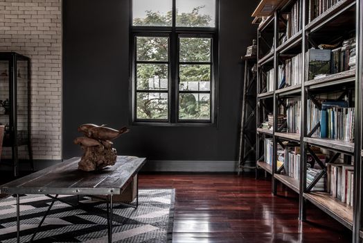 Bangkok, Thailand - 15 Dec 2019 : Minimalist modern living room with wooden table and brick wall in loft style.