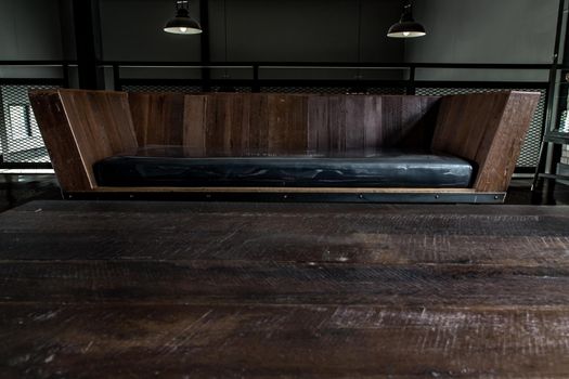 Bangkok, Thailand - 15 Dec 2019 : Living room in industrial style with sofa and wooden table on mezzanine floor.