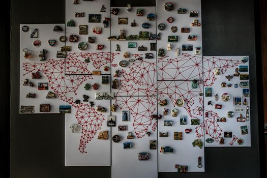 Bangkok, Thailand - 15 Dec 2019 : Refrigerator magnets from different cities of the world on whiteboard in loft style home, Popular souvenir and collectible objects.